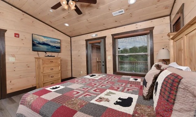 bedroom with wooden walls, wood ceiling, vaulted ceiling, and wood finished floors