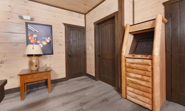 interior space with wood ceiling, wood walls, and wood finished floors