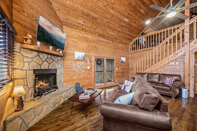 living room with high vaulted ceiling, wooden ceiling, wooden walls, and a fireplace