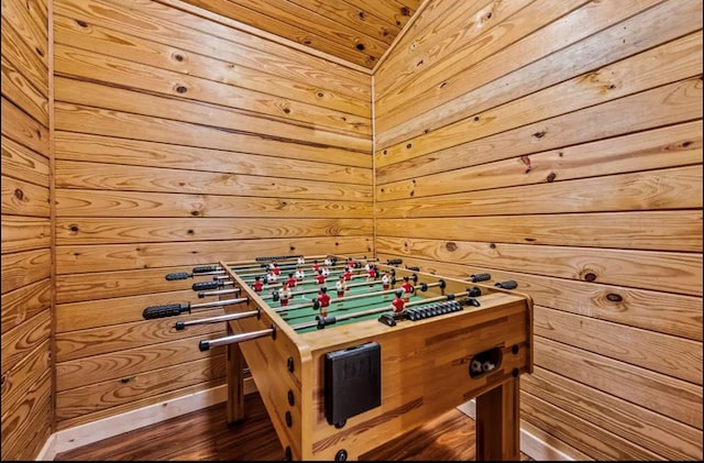 game room with wood ceiling and wood walls