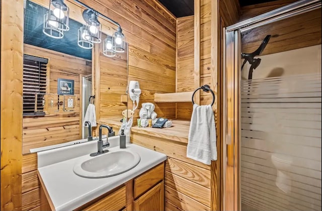 bathroom with walk in shower, vanity, and wooden walls