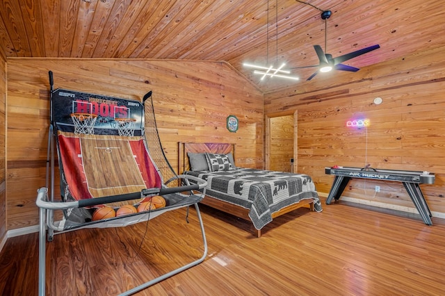 bedroom with wood walls, wooden ceiling, vaulted ceiling, and hardwood / wood-style floors