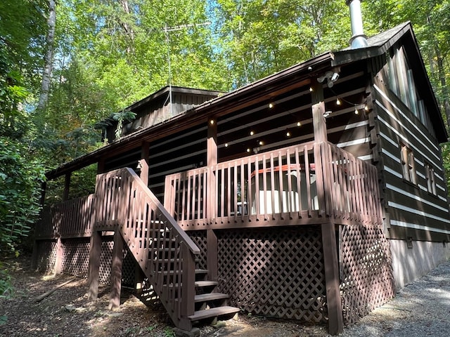 rear view of property featuring a deck