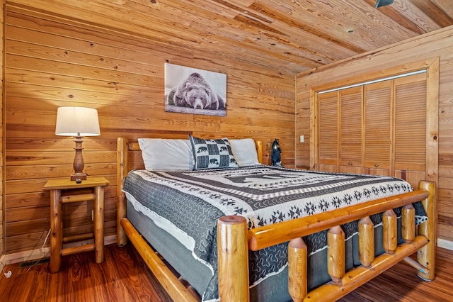 bedroom featuring wood-type flooring, a closet, wood ceiling, and wooden walls