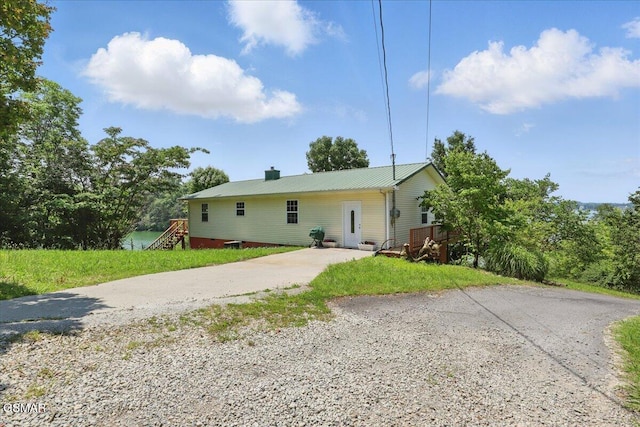 1381 Lake Front Dr, Dandridge, TN 37725 - back of house featuring driveway, a chimney, and metal roof
