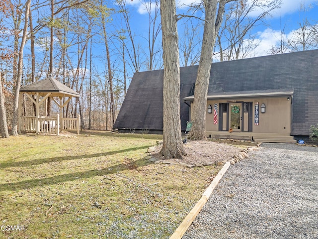 view of front of house with a front yard and a gazebo