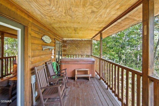 wooden terrace with a hot tub