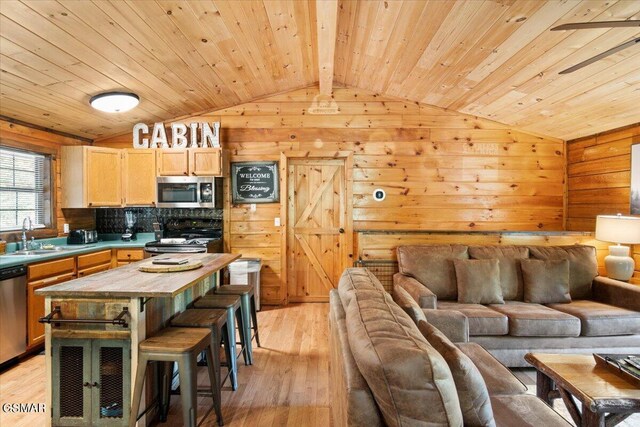 living room featuring vaulted ceiling with beams, wooden ceiling, sink, and light hardwood / wood-style flooring