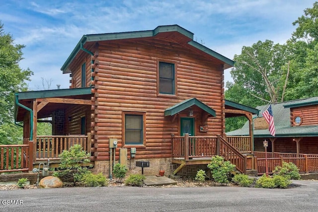 log-style house featuring a porch