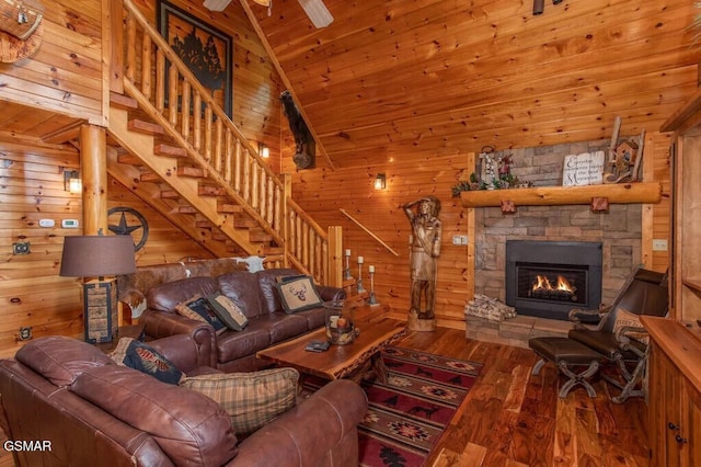 living room with wood walls, hardwood / wood-style floors, high vaulted ceiling, a fireplace, and wooden ceiling