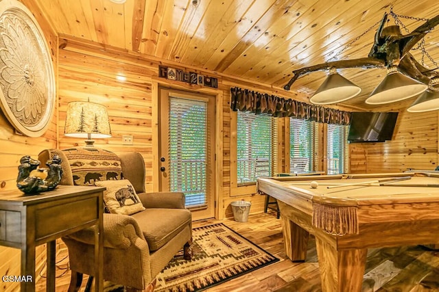 recreation room with light hardwood / wood-style floors, wooden ceiling, wood walls, and pool table