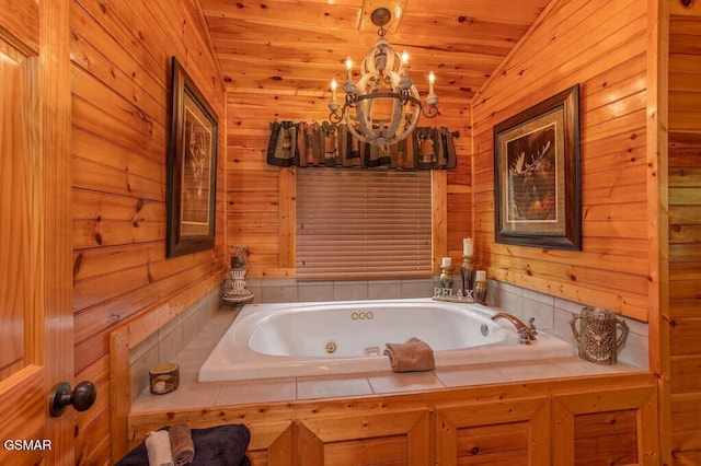 bathroom featuring lofted ceiling, tiled bath, wood walls, and wooden ceiling