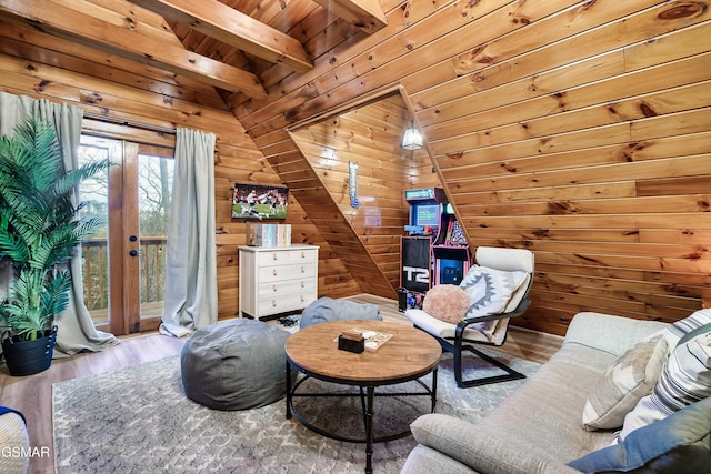 living area with wood ceiling, wooden walls, wood finished floors, and beamed ceiling