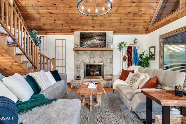 living area with wood ceiling, a fireplace, vaulted ceiling, and stairs