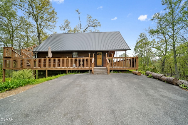 chalet / cabin with covered porch and metal roof