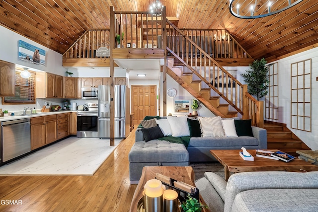 living area with high vaulted ceiling, wooden ceiling, light wood-style floors, and stairway