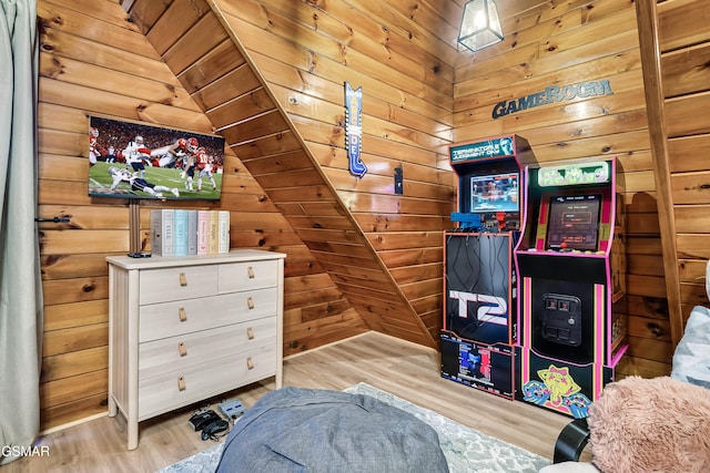 rec room with wooden walls and wood finished floors