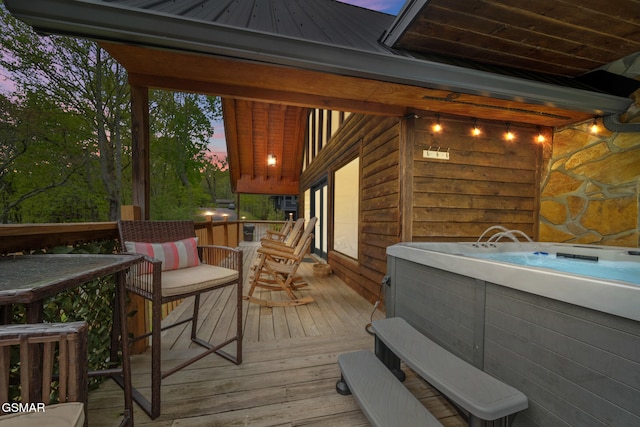 wooden deck featuring a hot tub