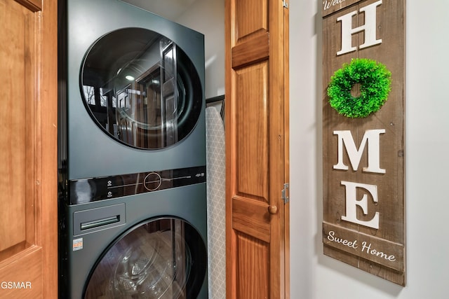 laundry room featuring stacked washer / dryer and laundry area