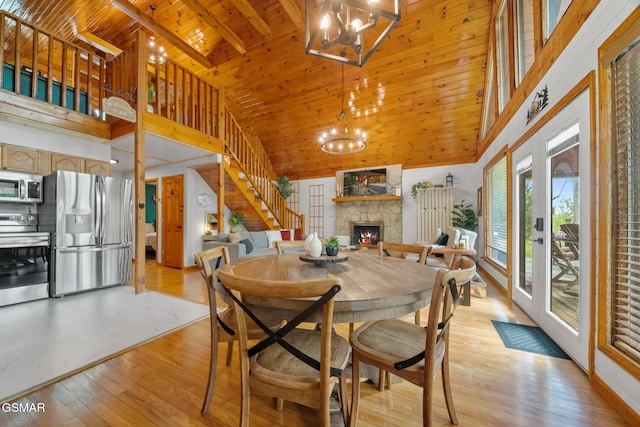 dining area featuring stairs, high vaulted ceiling, and a chandelier