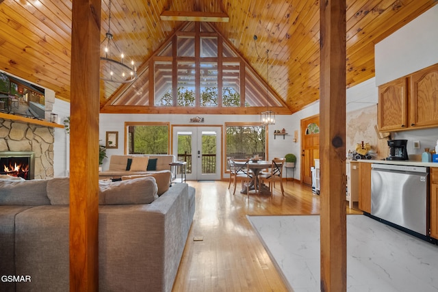 living area featuring light wood finished floors, french doors, wood ceiling, a stone fireplace, and high vaulted ceiling