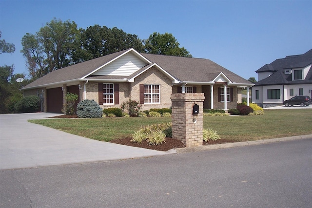 view of front of property featuring a garage and a front lawn