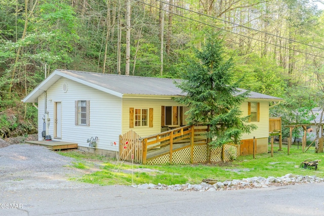 250 Cartertown Rd, Gatlinburg, TN 37738 - view of front facade with covered porch, a view of trees, and metal roof