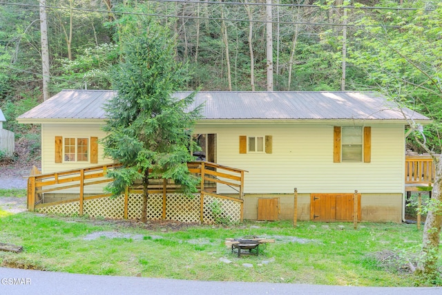 250 Cartertown Rd, Gatlinburg, TN 37738 - back of property with a fire pit, a lawn, and metal roof