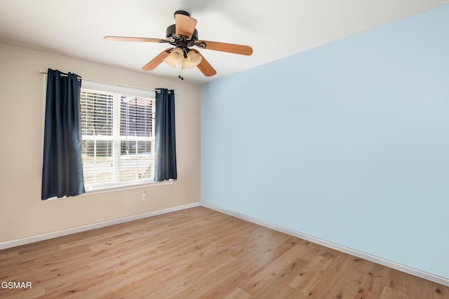 spare room featuring light wood-type flooring and ceiling fan