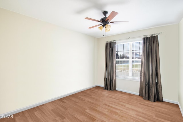 empty room featuring light wood-type flooring and ceiling fan