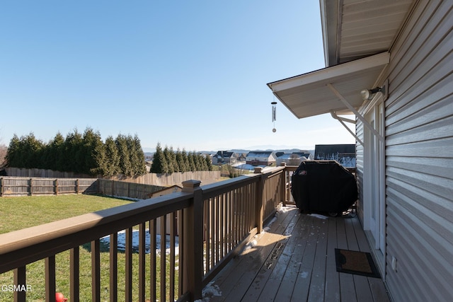 wooden deck featuring a yard and grilling area