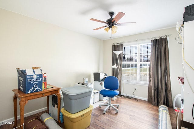 home office featuring ceiling fan and light hardwood / wood-style floors