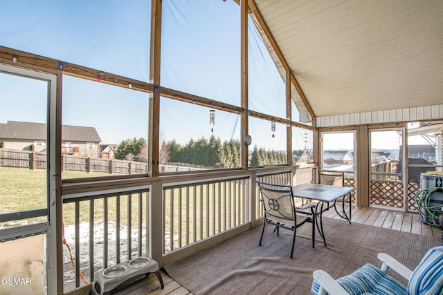 sunroom featuring vaulted ceiling