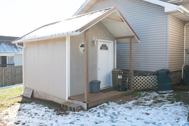 view of snow covered property entrance