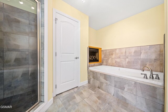 bathroom featuring tile patterned floors and shower with separate bathtub