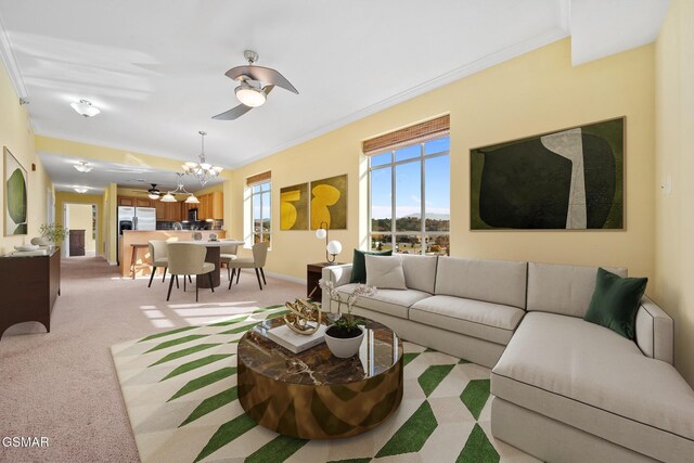 living room with crown molding, light colored carpet, and ceiling fan with notable chandelier