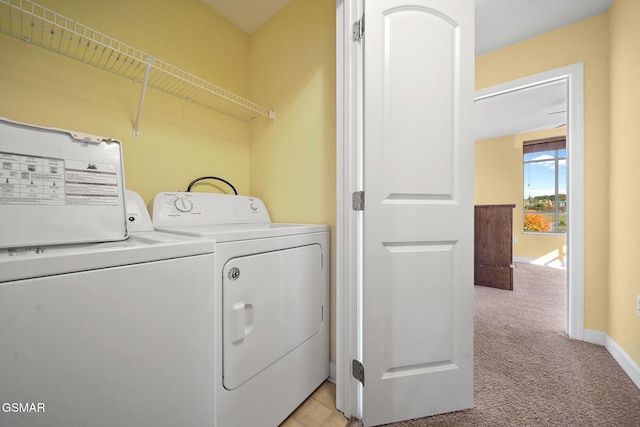 washroom featuring washing machine and clothes dryer and light carpet