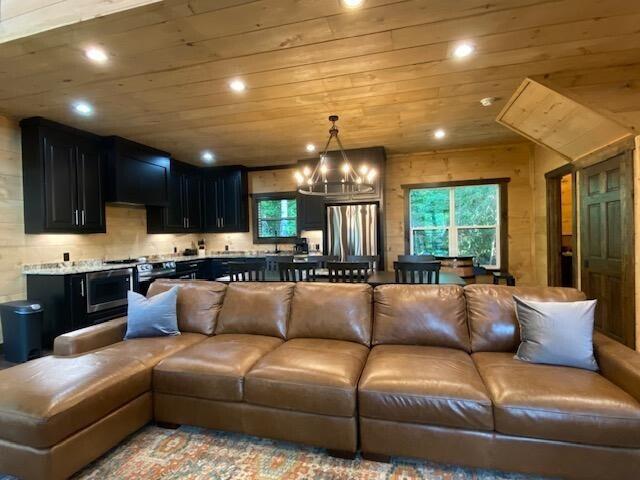 living room with wooden ceiling and an inviting chandelier