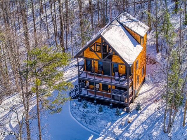 snow covered property with a balcony