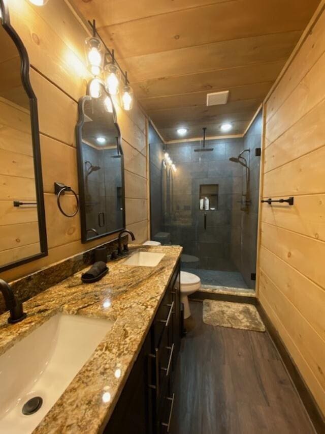 bathroom featuring toilet, wood-type flooring, wooden walls, wood ceiling, and an enclosed shower