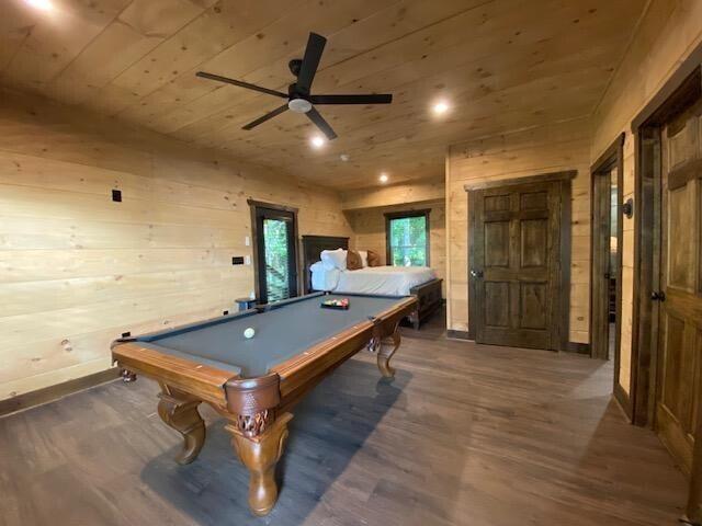 game room featuring wood ceiling, dark wood-type flooring, pool table, wooden walls, and ceiling fan