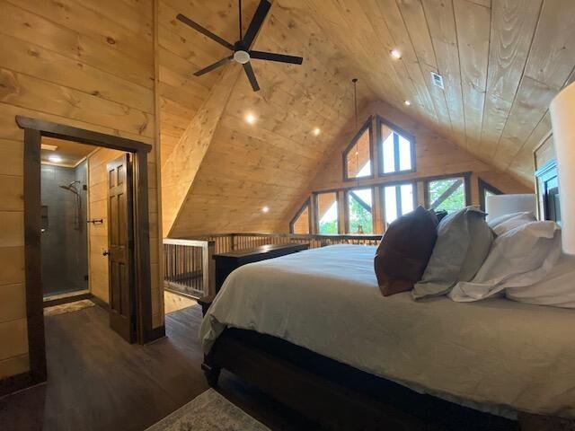 bedroom featuring lofted ceiling, dark hardwood / wood-style floors, wood walls, ceiling fan, and wooden ceiling