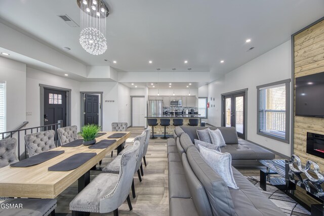 1349 N Baden Dr, Gatlinburg, TN 37738 - dining area featuring light wood-style floors, recessed lighting, a fireplace, plenty of natural light, and a chandelier