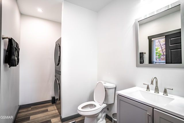 1349 N Baden Dr, Gatlinburg, TN 37738 - bathroom with stacked washer / dryer, wood finished floors, vanity, and toilet