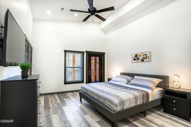 1349 N Baden Dr, Gatlinburg, TN 37738 - bedroom with access to exterior, multiple windows, a high ceiling, wood finished floors, and recessed lighting