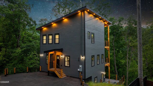 1349 N Baden Dr, Gatlinburg, TN 37738 - back of house at twilight with a wooden deck, central AC, and a patio area