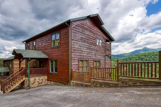 view of property exterior with a mountain view