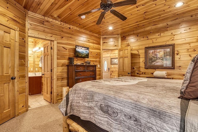 bedroom featuring ceiling fan, wooden ceiling, ensuite bathroom, and light carpet