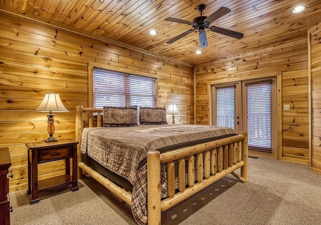 carpeted bedroom with ceiling fan, wood ceiling, and wooden walls