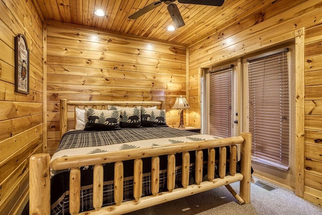 bedroom with carpet, wooden walls, ceiling fan, and wooden ceiling